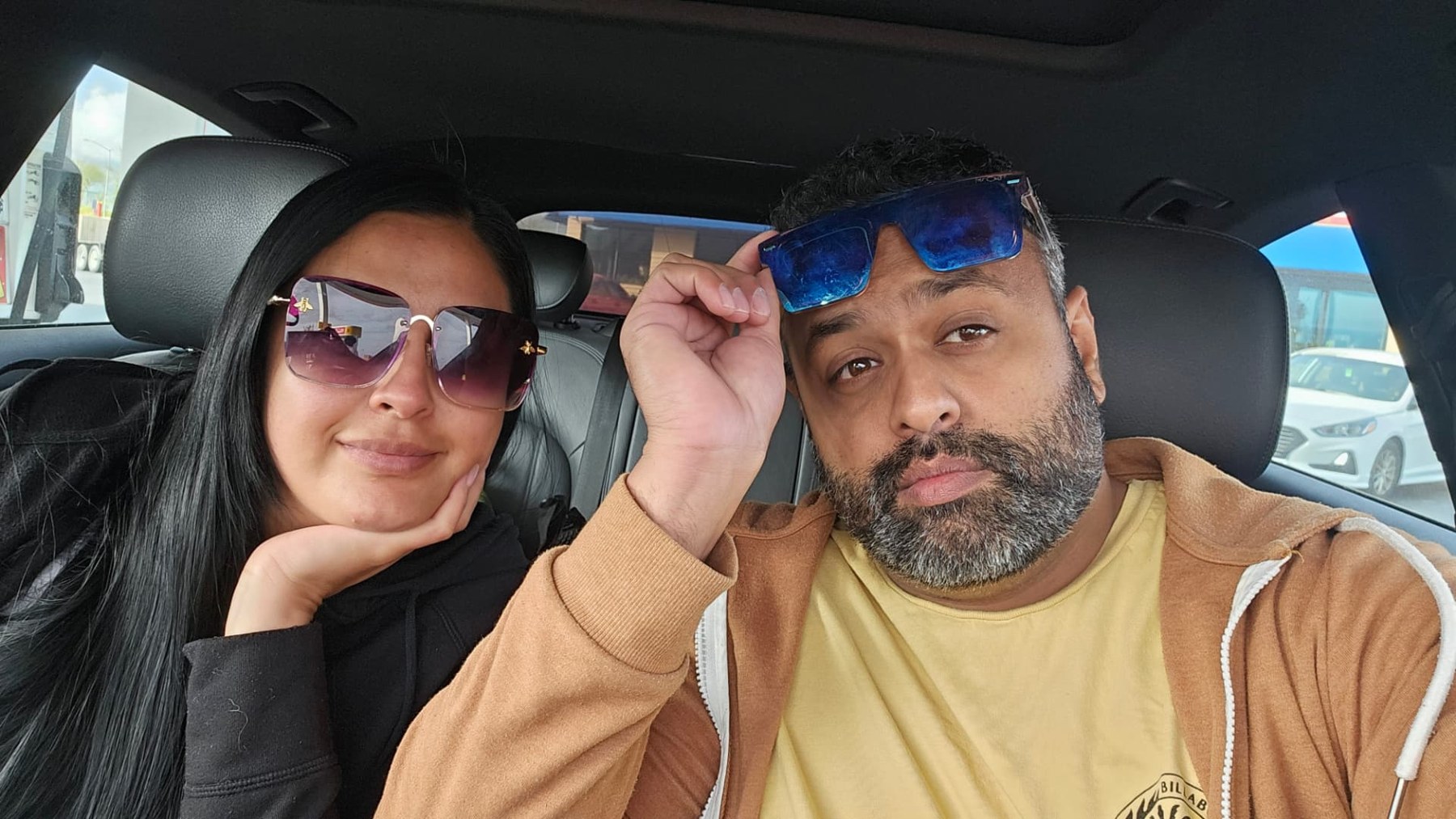 Margarita and Samir wearing sunglasses on a road trip