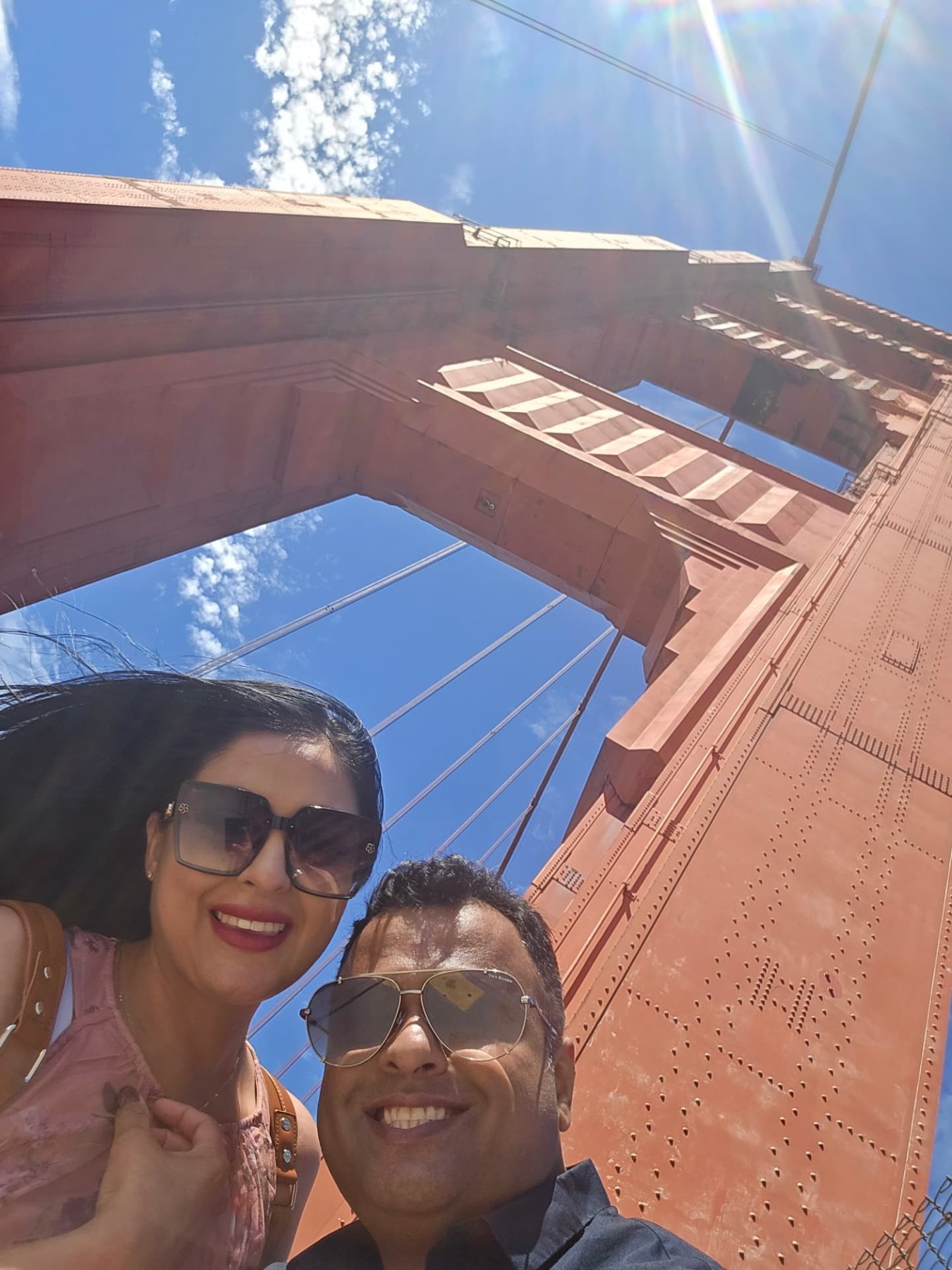 Margarita and Samir beneath the Golden Gate Bridge