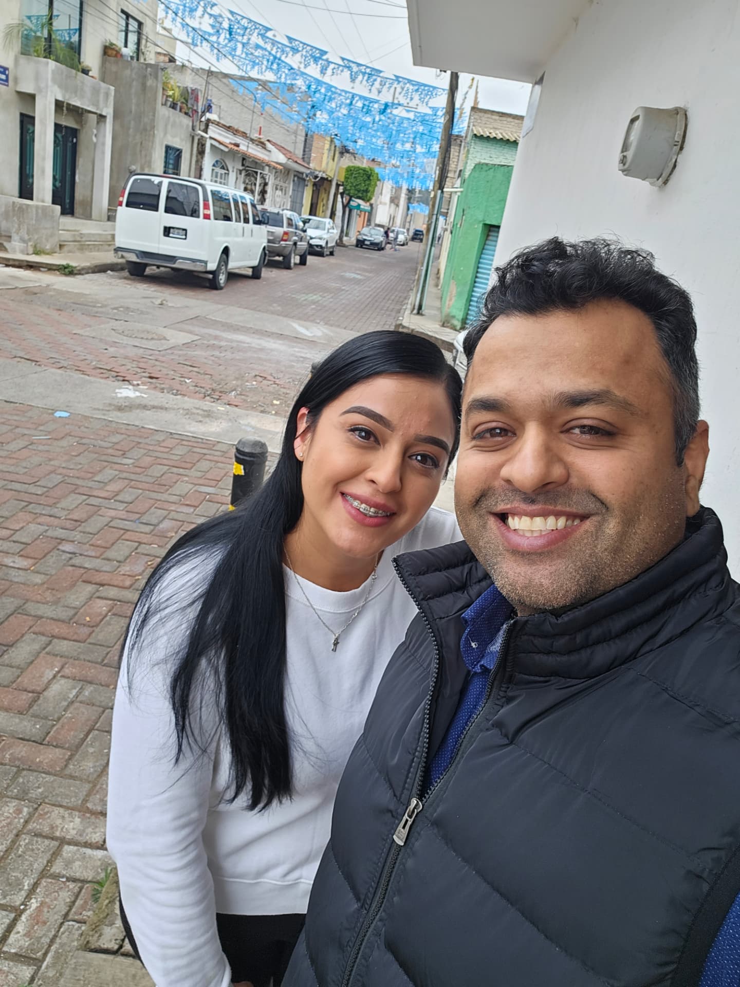 Margarita and Samir together on a colorful street in México