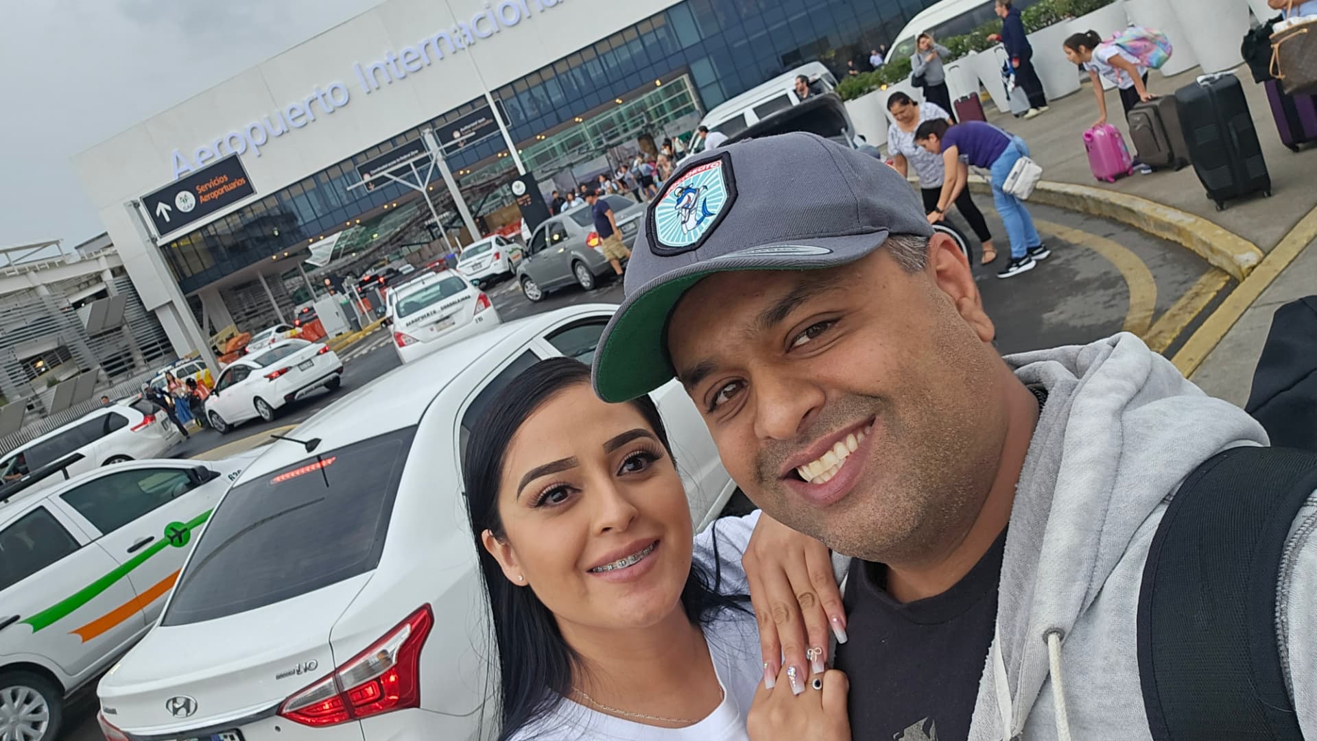 Margarita and Samir taking a selfie outside Guadalajara's international airport